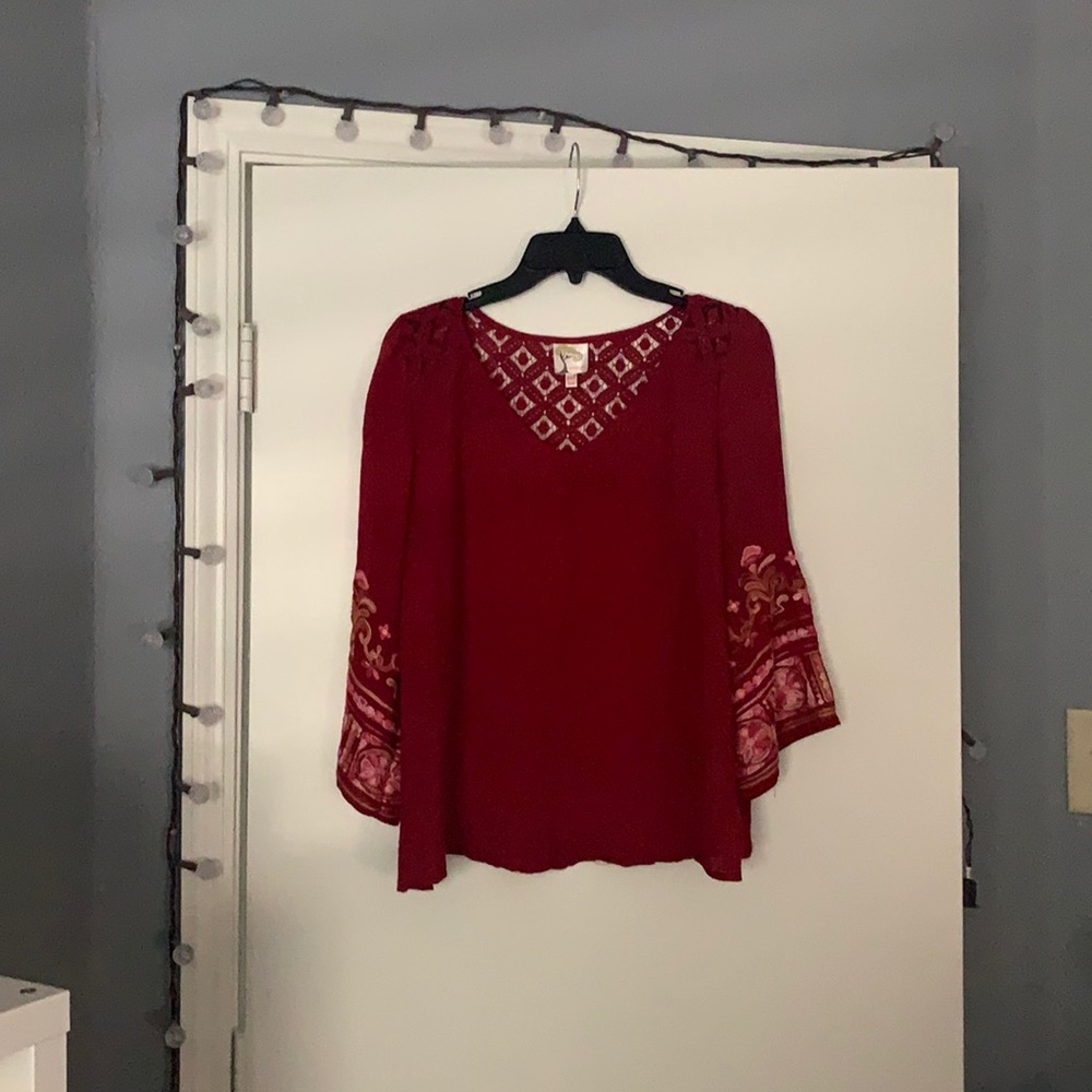 Red blouse w/ design on the sleeves